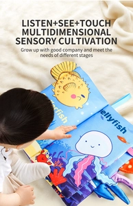 Close-up of a soft sensory fabric book with ocean animal tails on a white plush carpet