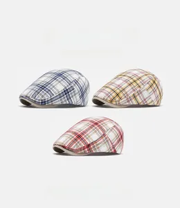 Detailed close-up of plaid newsboy caps in three colors with breathable cotton texture
