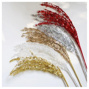 Close-up of glittered Christmas tree floral picks in red, gold, silver, and champagne
