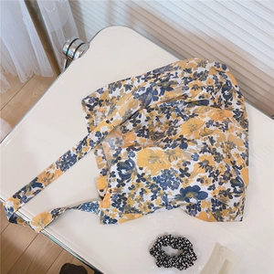 Detail of floral cotton tote bag with vintage yellow and navy patterns on a white desk