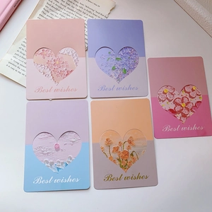 Detailed flat lay of five 3D greeting cards with heart cutouts and floral patterns