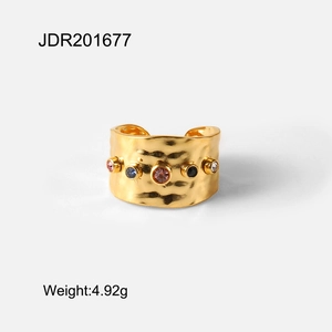 Irregular textured gold ring with colorful gemstones and hammered finish style