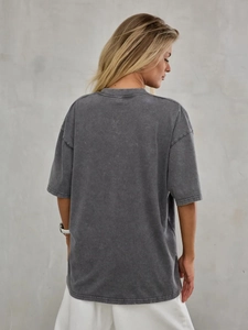 Detail of oversized washed grey cotton T-shirt featuring vintage texture and drop shoulder