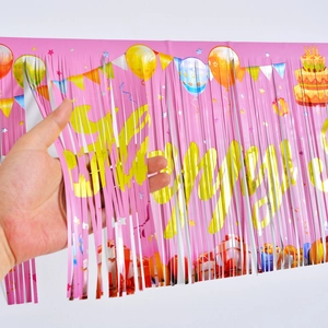 Pink foil fringe curtain for birthday party backdrop with festive birthday motifs