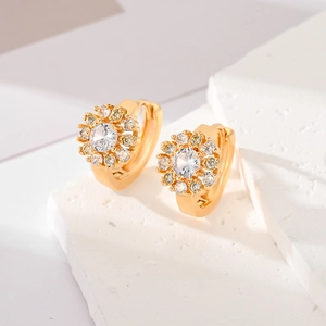 Macro shot of gold sunflower hoop earrings featuring sparkling pavé zircon detail