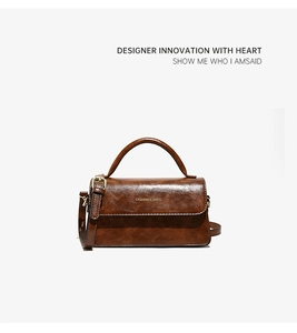 Dettaglio borsa a mano vintage in pelle marrone con elegante chiusura in metallo