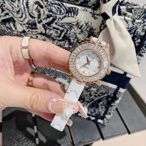 Detail of white ceramic watch with rose gold bezel and crystals on mother of pearl dial