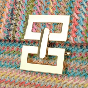 Handmade woven colorful straw handbag for women with a gold square metal lock closure