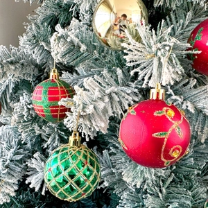 6cm painted Christmas ball ornaments in red, green, and gold on a snowy tree branch