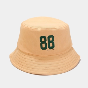 Close-up of number 88 print and text on canvas cotton bucket hat in peach pink