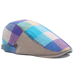 Detail of colorful plaid ivy cap showing fabric texture and adjustable metal buckle