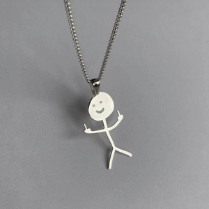 Close-up of funny doodle matchstick man pendant on a silver metal necklace chain