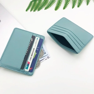 Minimalist light blue PU leather card holder with multiple slots on a desk setting