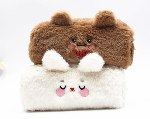 Detail of plush bear and rabbit pencil cases showing soft texture and embroidery