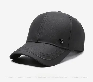 Detail view of the black baseball cap showing the side JB metal logo and canvas texture