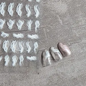 Macro detail of white smoke nail stickers showing ultra-thin texture and manicured effect