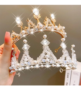 Detail of luxury gold and silver tiaras with sparkling crystals and pearls for girls