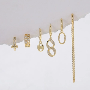6-piece gold chain link earring set with zircon accents on a creative white background