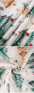 Macro detail of Christmas fabric with festive tree prints and woven linen texture
