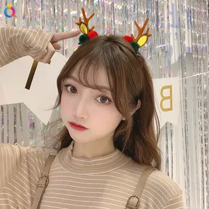 Close-up of reindeer antler hair clips with plush pom-poms for Christmas themed styling