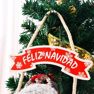 Detail of red Feliz Navidad felt banner with plush gnome on Christmas tree branch