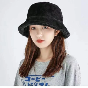 Close-up of fluffy black faux rabbit fur bucket hat showing plush texture and warmth