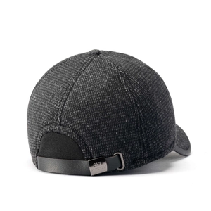 Detail of grey plaid baseball cap showing leather strap and metallic buckle adjustment