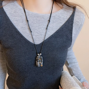 Detail of vintage beaded necklace with stone pendant on an adjustable black cord