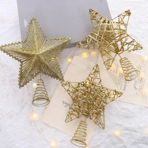 Three gold glitter Christmas tree topper stars on a cozy white fur background