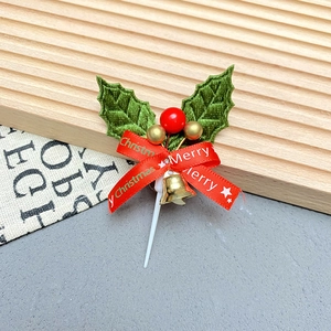 Detailed Christmas cake topper with holly leaves, red berry, gold bell and Merry Christmas ribbon