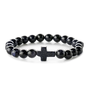 Blue sand stone beaded bracelet with cross pendant on a clean white background