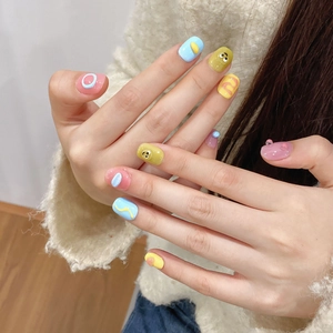Sweet macaron pastel press-on nails with 3D embossed cartoon eyes and colorful wave patterns