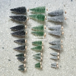 Close-up of mini sisal Christmas trees in black, green, and silver with wooden bases