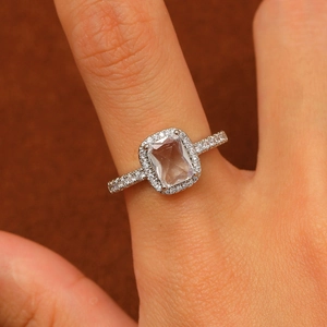 Macro shot of silver ring featuring square-cut clear zircon and side diamond accents