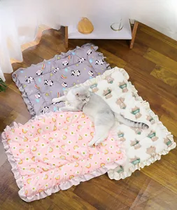 Detail of plush pet mats in cow, bear, and rainbow prints with elegant ruffled edges