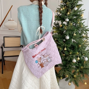 Detail of light purple quilted tote bag featuring cute animal embroidery and soft texture