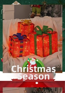 Detail of warm LED Christmas gift boxes with festive red glitter and colorful bows