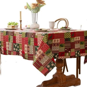 Vintage Christmas tablecloth with jacquard reindeer and snowflake patterns on a dining table