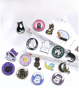 Detailed macro shot of creative cartoon cat enamel pins and Bad Bitch Club metal badges