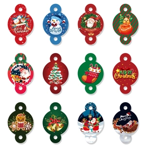 Detailed flat lay of 12 festive round Christmas paper tags featuring various holiday motifs