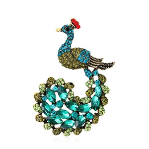Detailed view of peacock brooch featuring vintage metal and colorful crystal rhinestones
