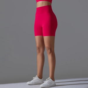 Detail of rose red seamless ribbed high waist yoga shorts with peach lift compression texture