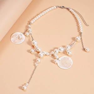 Detail view of pearl and shell beaded necklace with elegant layered metallic chain