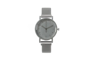 Macro detail of silver mesh Milanese watch strap and gray dial with numeric markers