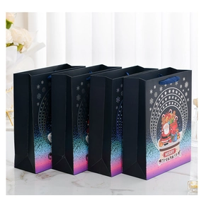 Detail of four dark blue Christmas gift bags with ribbon handles and snow globe graphics
