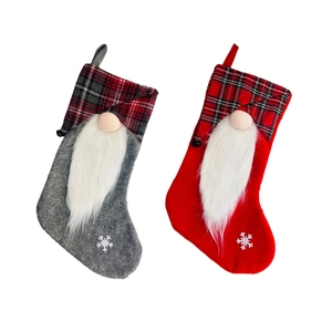 Christmas gnome stockings in red and grey plaid with snowflake decor and white fur beard