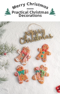 Detailed view of gingerbread man ornaments and wooden Merry Christmas sign on faux snow