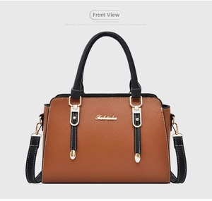 Detailed front view of brown and black leather tote bag with gold logo and shoulder strap