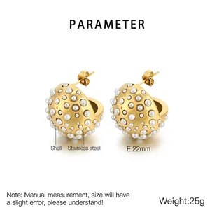 Macro detail of 22mm golden semi-sphere earrings with shell pearl inlay and 18K finish