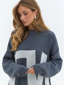 Close-up of dark grey knit sweater featuring white number 71 jacquard and ribbed texture